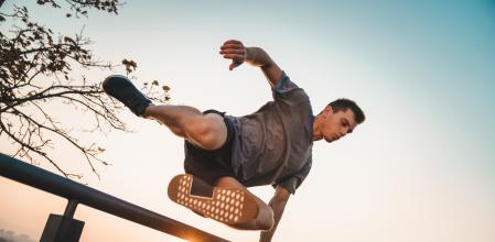 Athlete jumping over a wall.  Free running parkour - Stock photo